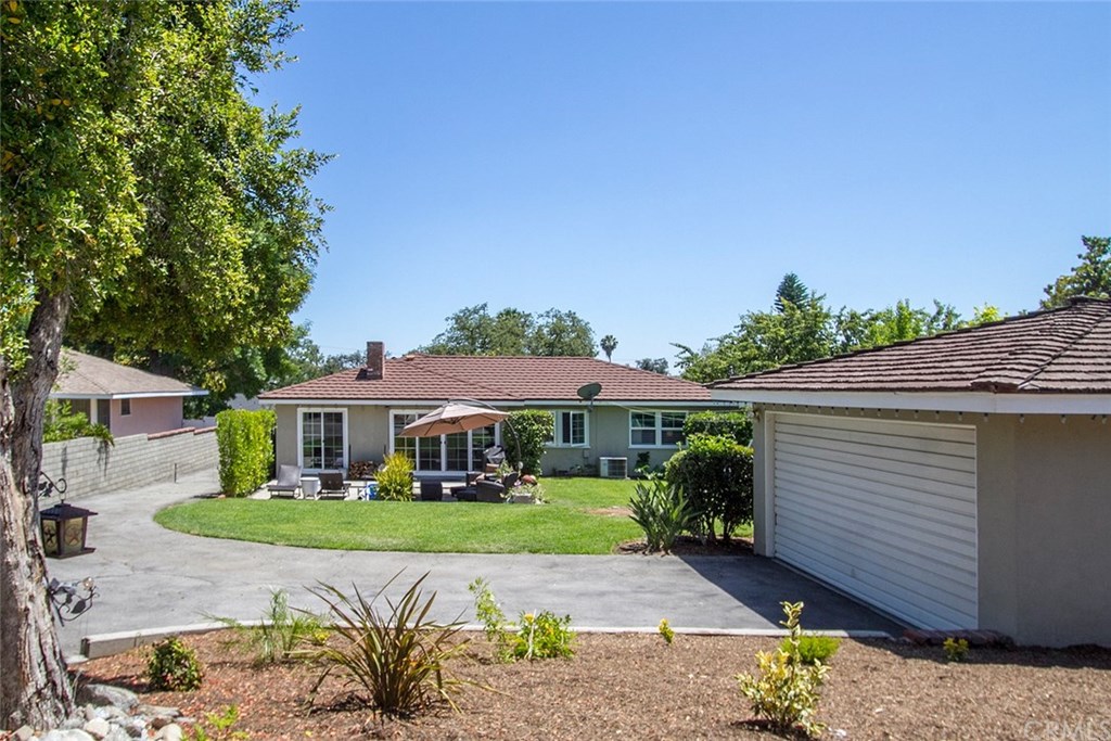3745 Landfair Road Pasadena, CA 91107 - Photo 24 of 25 a view of a white house with a yard and potted plants