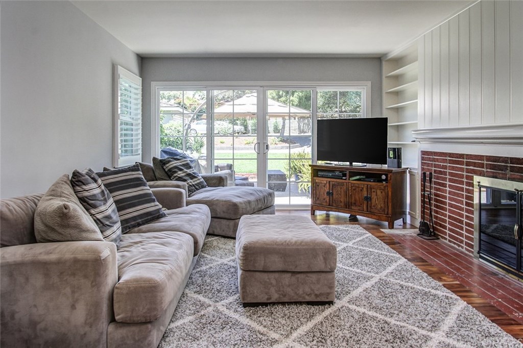 3745 Landfair Road Pasadena, CA 91107 - Photo 6 of 25 a living room with furniture a flat screen tv and a fireplace