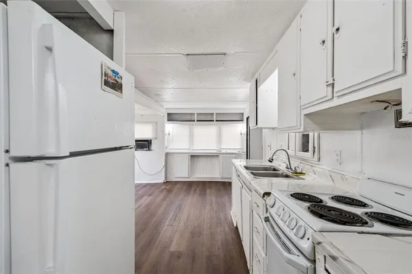 a view of empty room with window and wooden floor