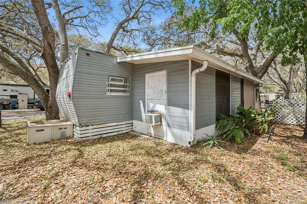 a backyard of a house with table and chairs