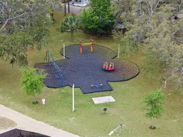 an aerial view of a house with outdoor space and a lake view