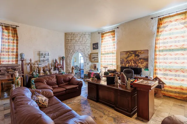 a living room with furniture and a floor to ceiling window