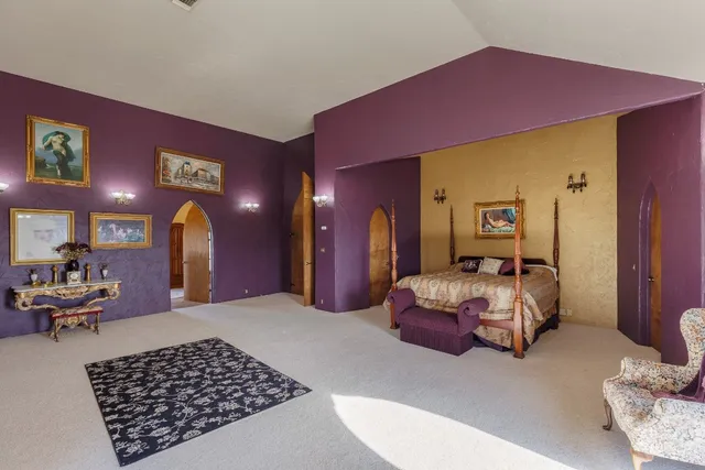 a bedroom with a bed and balcony view