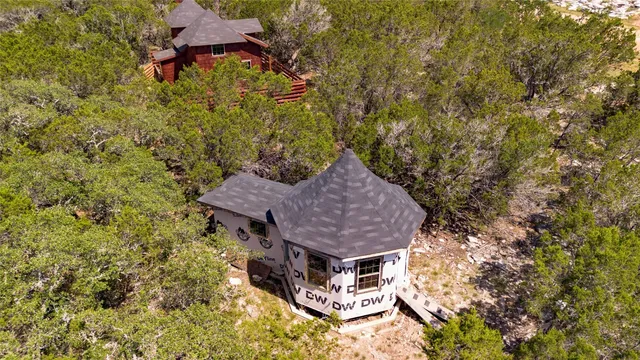 an aerial view of a house with a yard