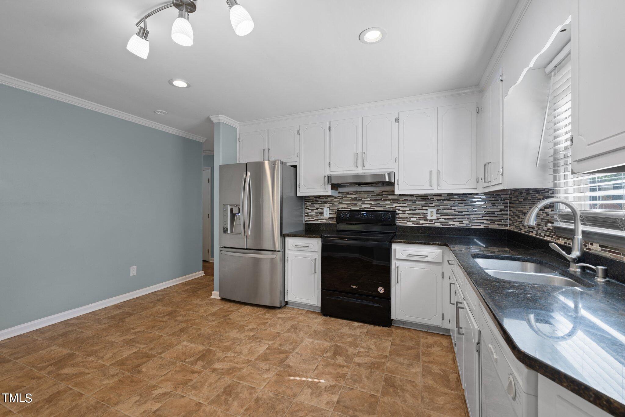 4209 Timberbrook Drive Raleigh, NC 27616 - Photo 14 of 39 a kitchen with a sink stove and refrigerator