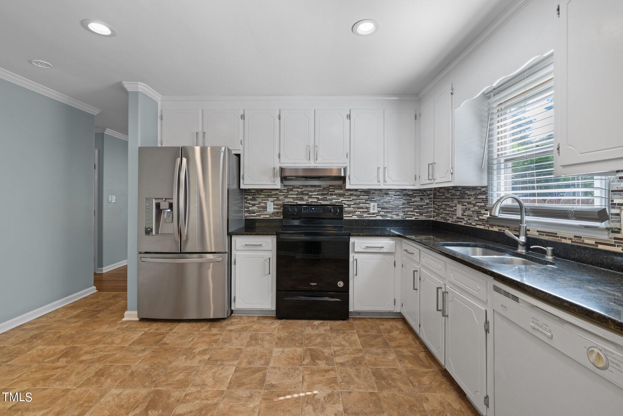 4209 Timberbrook Drive Raleigh, NC 27616 - Photo 15 of 39 a kitchen with a refrigerator and a sink