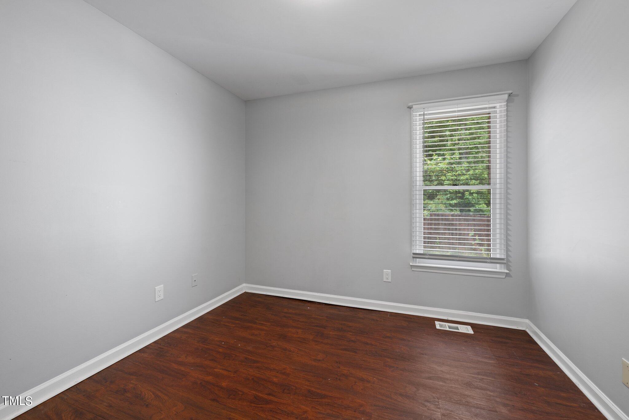 4209 Timberbrook Drive Raleigh, NC 27616 - Photo 20 of 39 a view of an empty room with wooden floor and a window