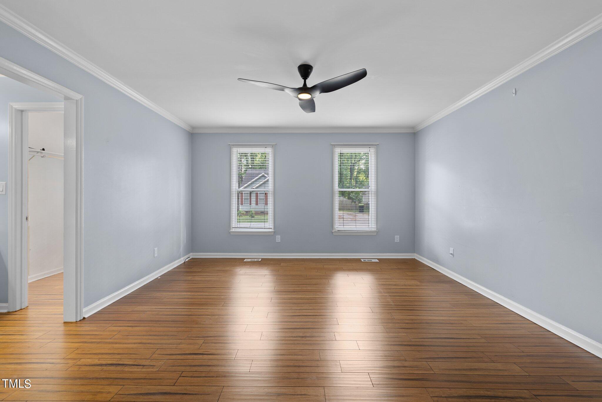 4209 Timberbrook Drive Raleigh, NC 27616 - Photo 21 of 39 a view of empty room with wooden floor and fan
