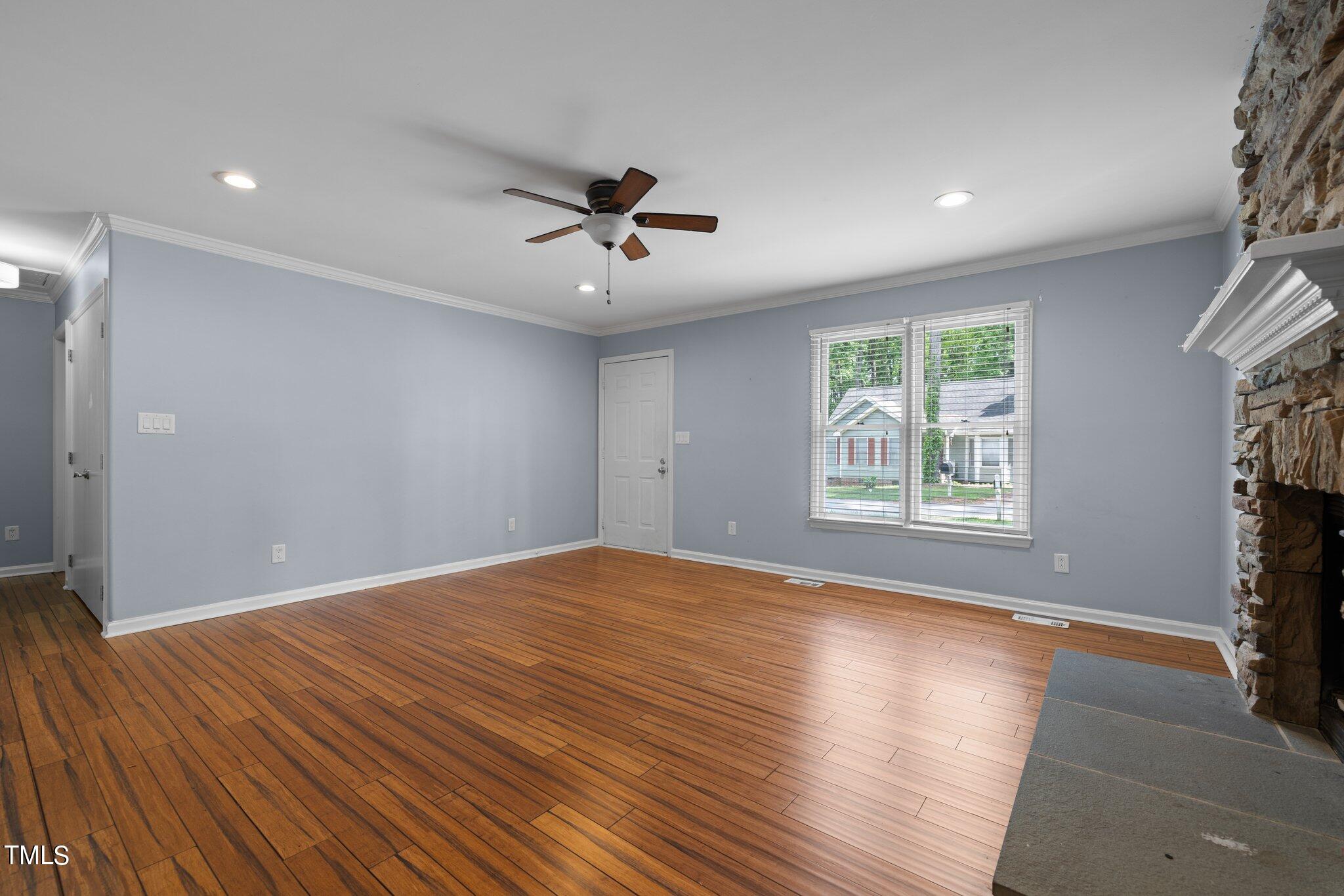 4209 Timberbrook Drive Raleigh, NC 27616 - Photo 7 of 39 a view of empty room with wooden floor and fan