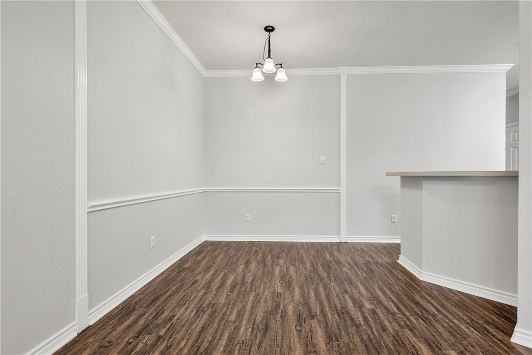 204 Fraternity Row College Station, TX 77845 - Photo 5 of 21 a view of a room with wooden floors and chandelier