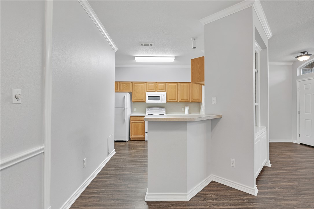 204 Fraternity Row College Station, TX 77845 - Photo 6 of 21 a view of a kitchen from the hallway