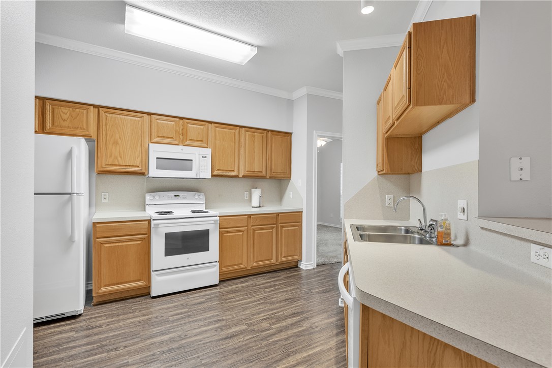 204 Fraternity Row College Station, TX 77845 - Photo 7 of 21 a kitchen with stainless steel appliances a sink cabinets and wooden floor