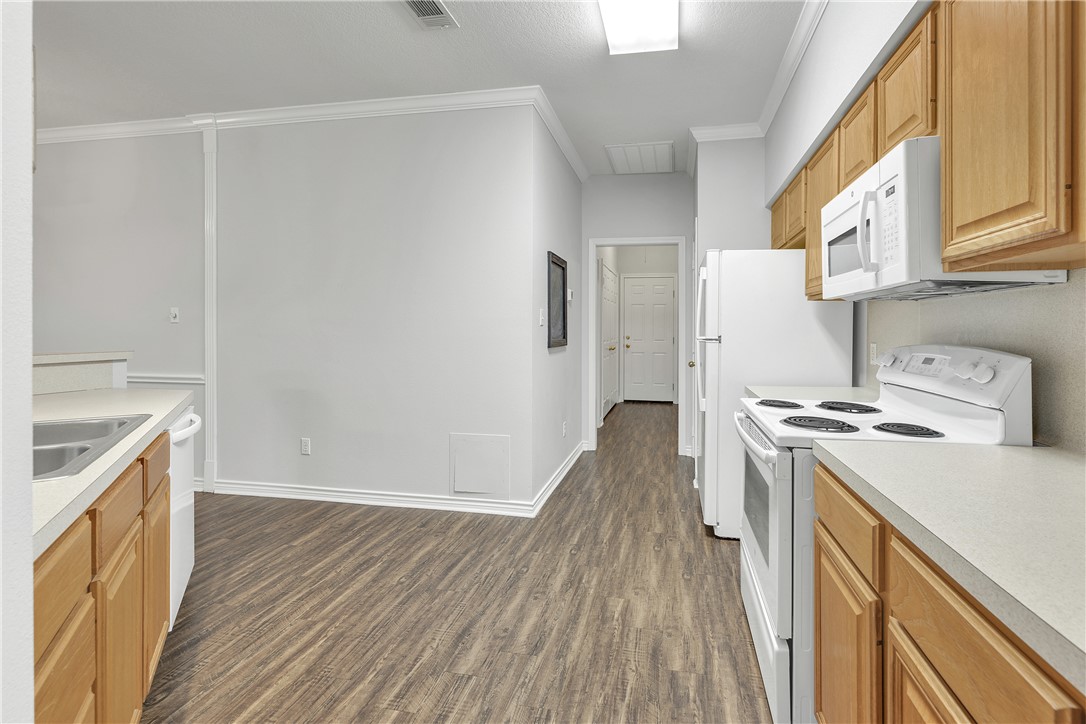 204 Fraternity Row College Station, TX 77845 - Photo 10 of 21 a kitchen with a wooden floor a stove and a refrigerator