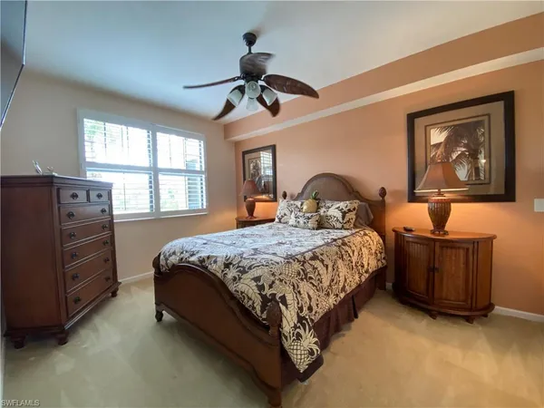 a bedroom with a bed dresser and wooden floor