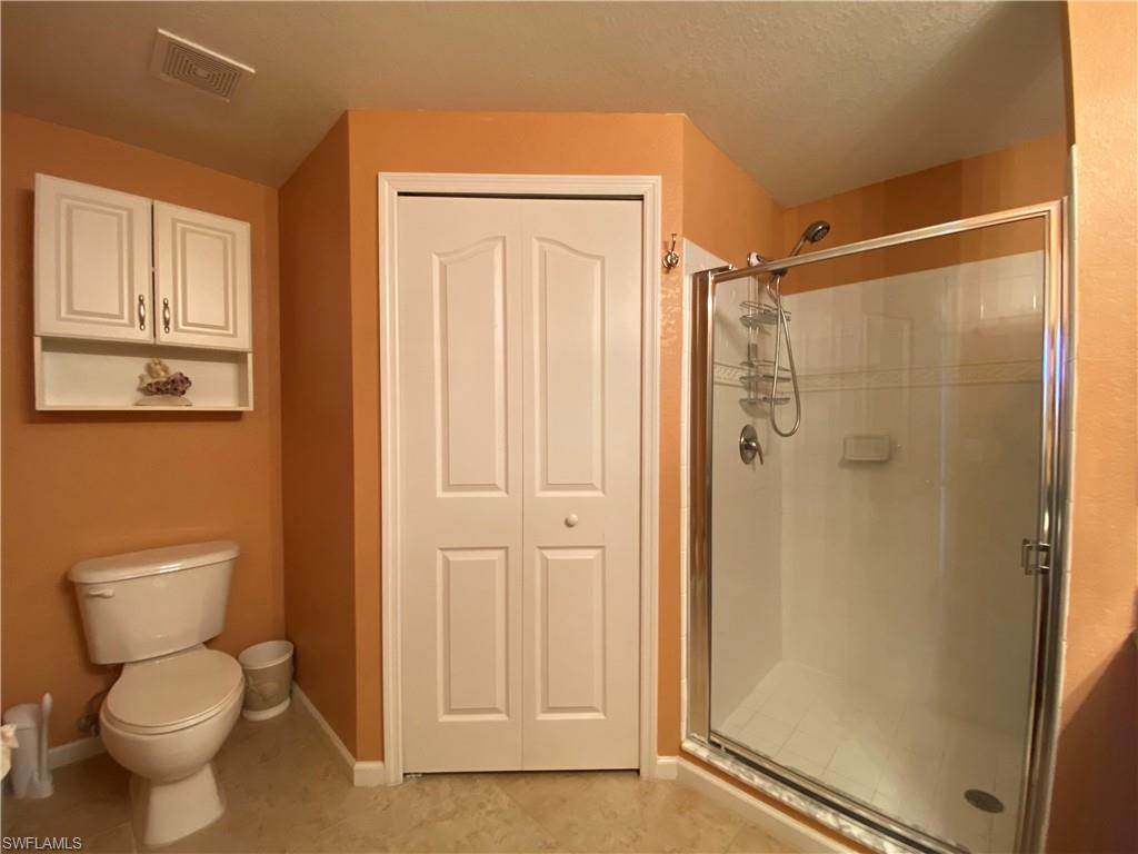 12940 Positano Circle, Unit 204 Naples, FL 34105 - Photo 15 of 39 a bathroom with a toilet and shower