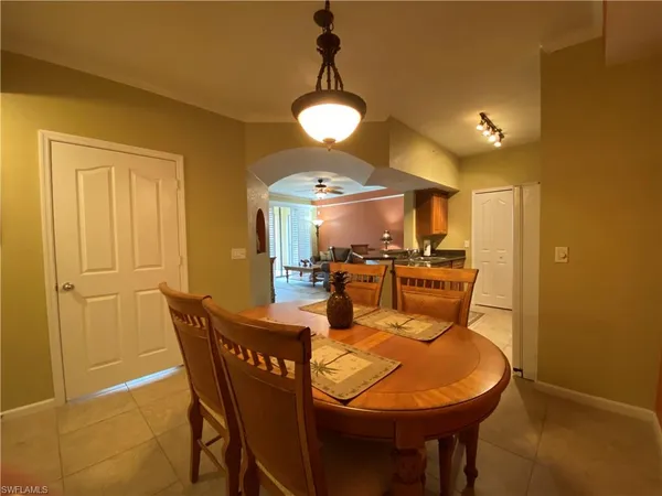 a view of a dining room with furniture and chandelier