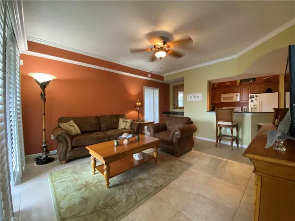 a living room with furniture a lamp and a flat screen tv