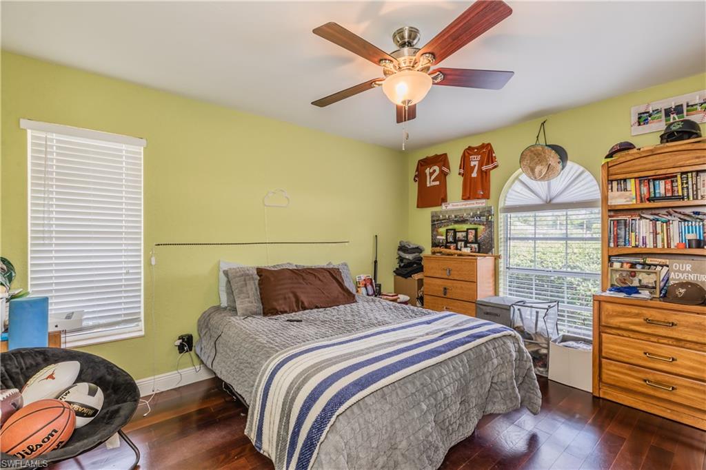 102 Cedar Crest Court Naples, FL 34113 - Photo 11 of 15 a bedroom with a bed and wooden floor