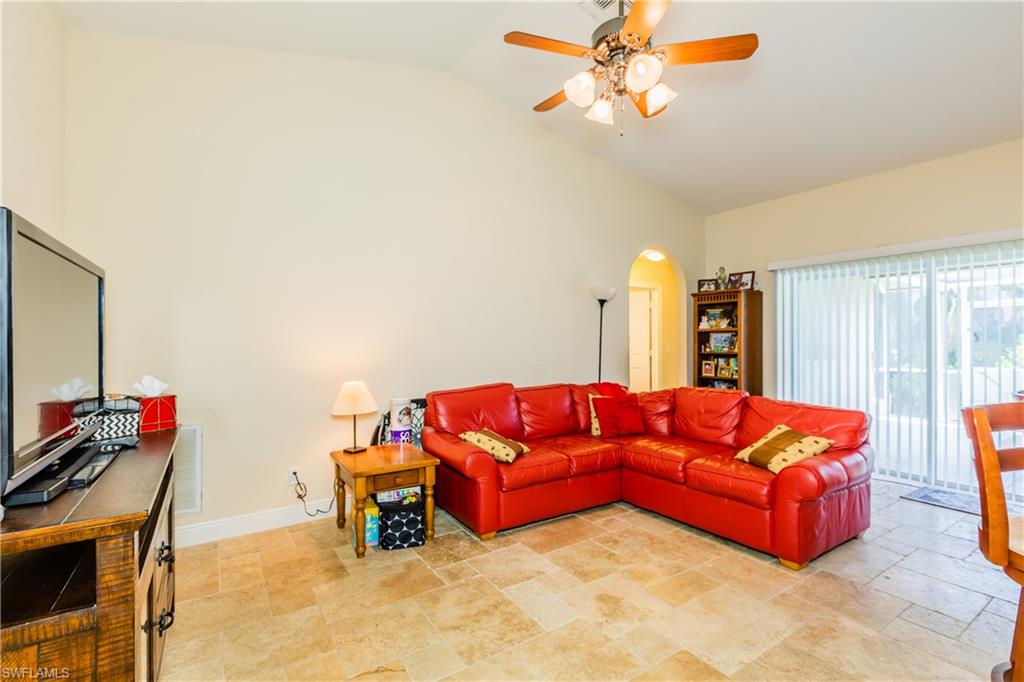 102 Cedar Crest Court Naples, FL 34113 - Photo 13 of 15 a living room with furniture and a flat screen tv