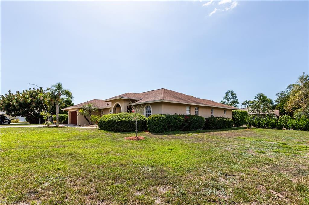 102 Cedar Crest Court Naples, FL 34113 - Photo 14 of 15 a view of a house with yard and a garden