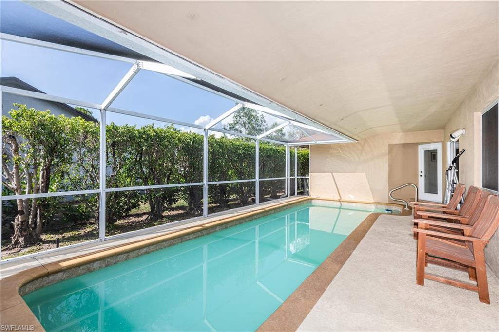 102 Cedar Crest Court Naples, FL 34113 - Photo 4 of 15 a view of a backyard with a swimming pool