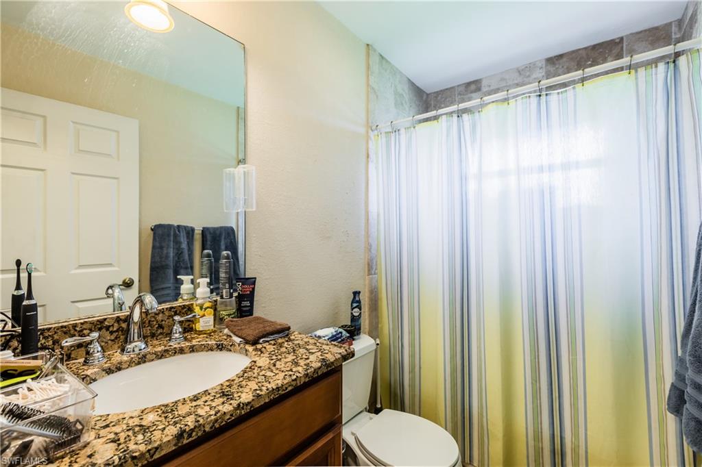 102 Cedar Crest Court Naples, FL 34113 - Photo 7 of 15 a bathroom with a granite countertop sink and a mirror