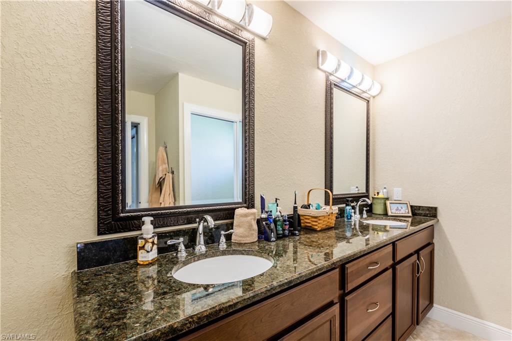 102 Cedar Crest Court Naples, FL 34113 - Photo 9 of 15 a bathroom with double vanity sinks and a mirror