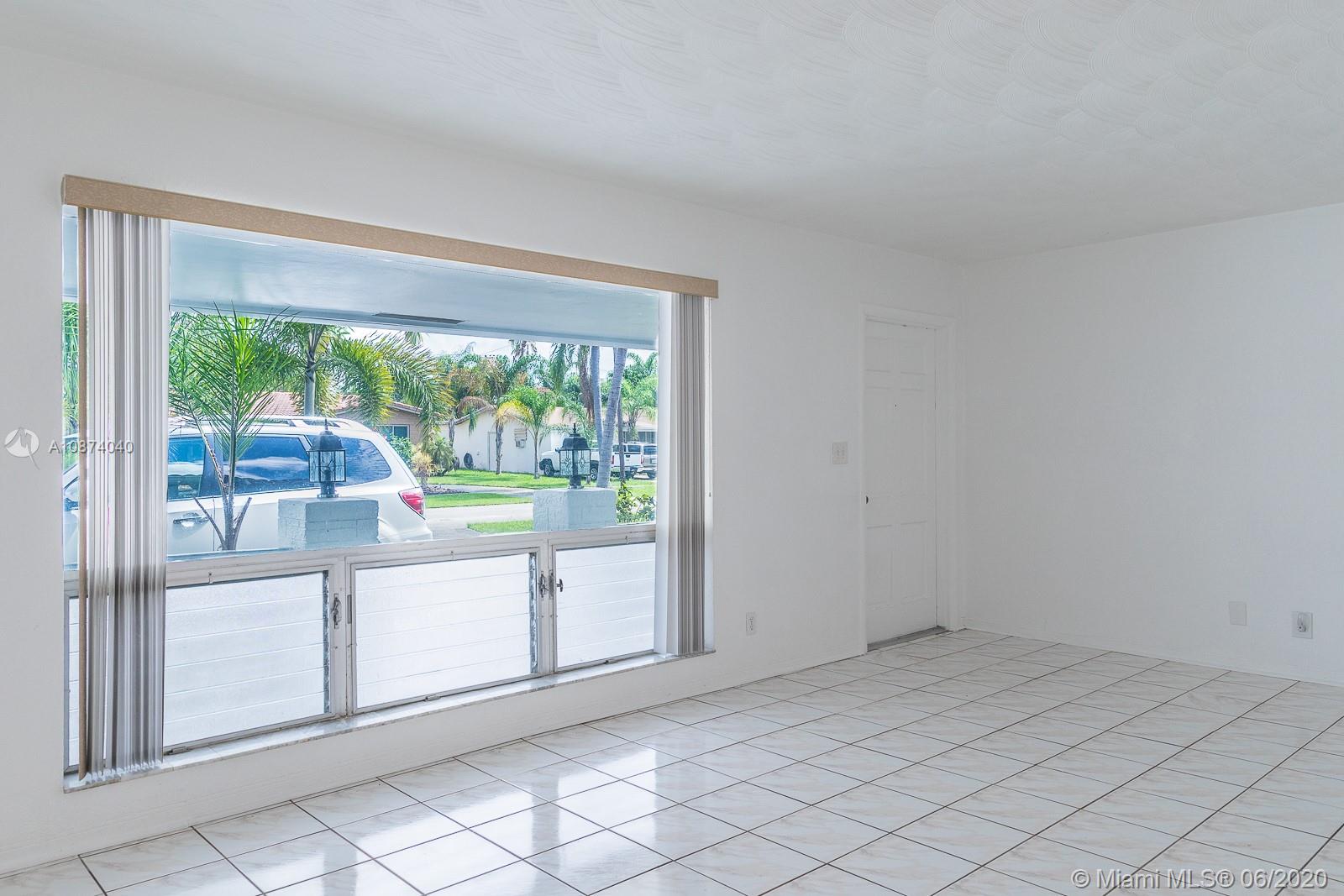 5416 Jefferson Street Hollywood, FL 33021 - Photo 12 of 70 a view of a big room with wooden floor and windows
