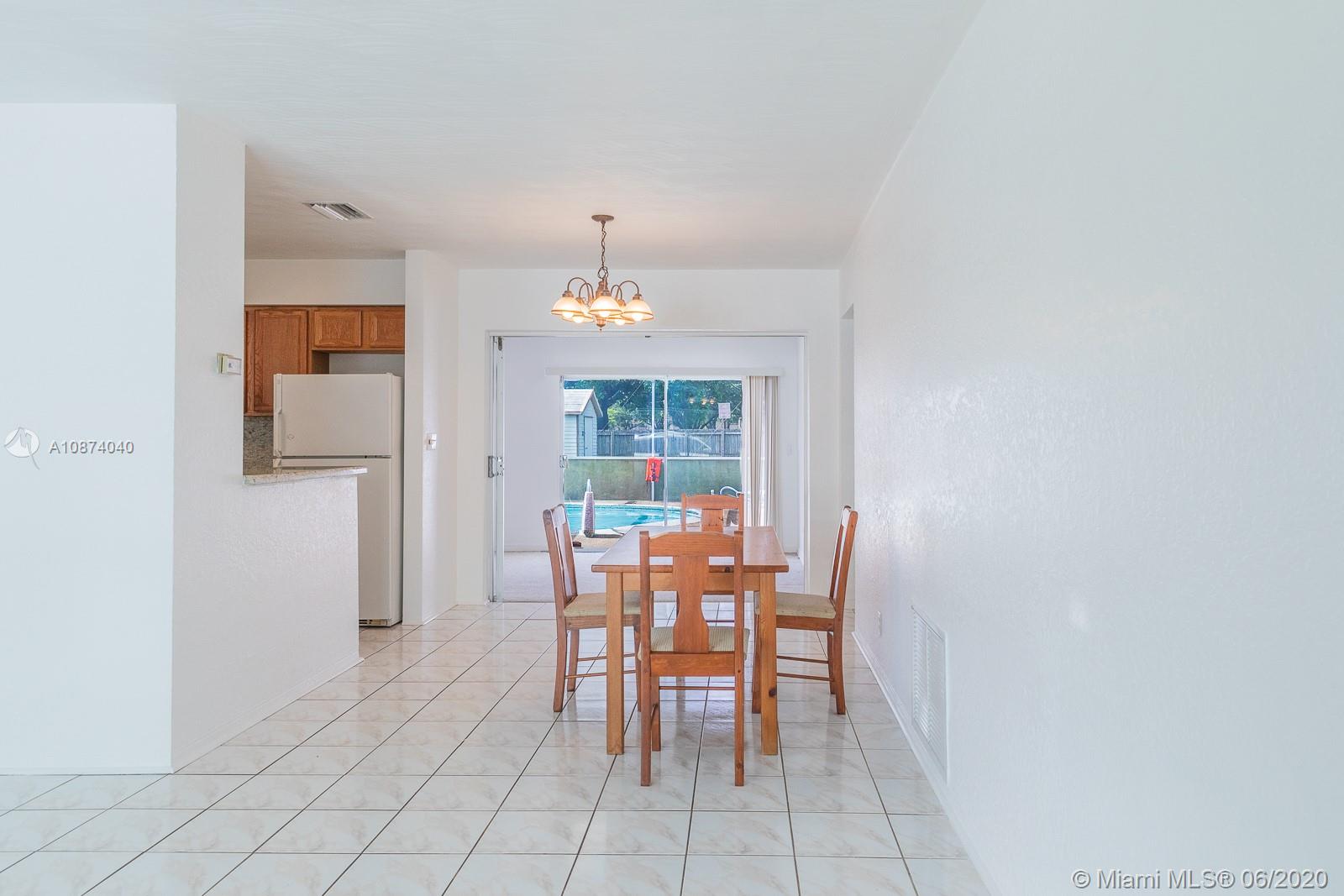 5416 Jefferson Street Hollywood, FL 33021 - Photo 15 of 70 a dining room with furniture and window