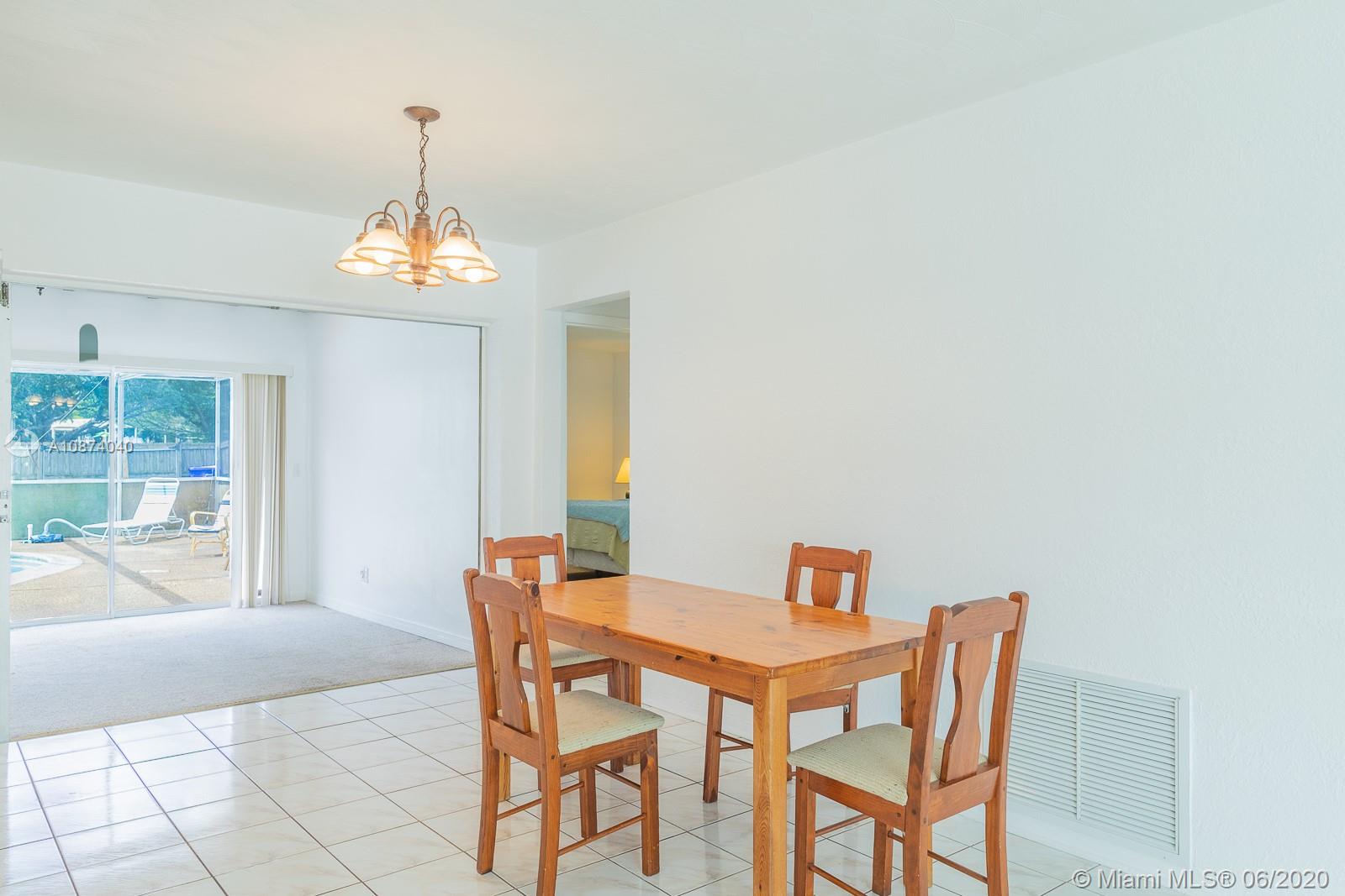 5416 Jefferson Street Hollywood, FL 33021 - Photo 16 of 70 a view of a dining room with furniture and chandelier
