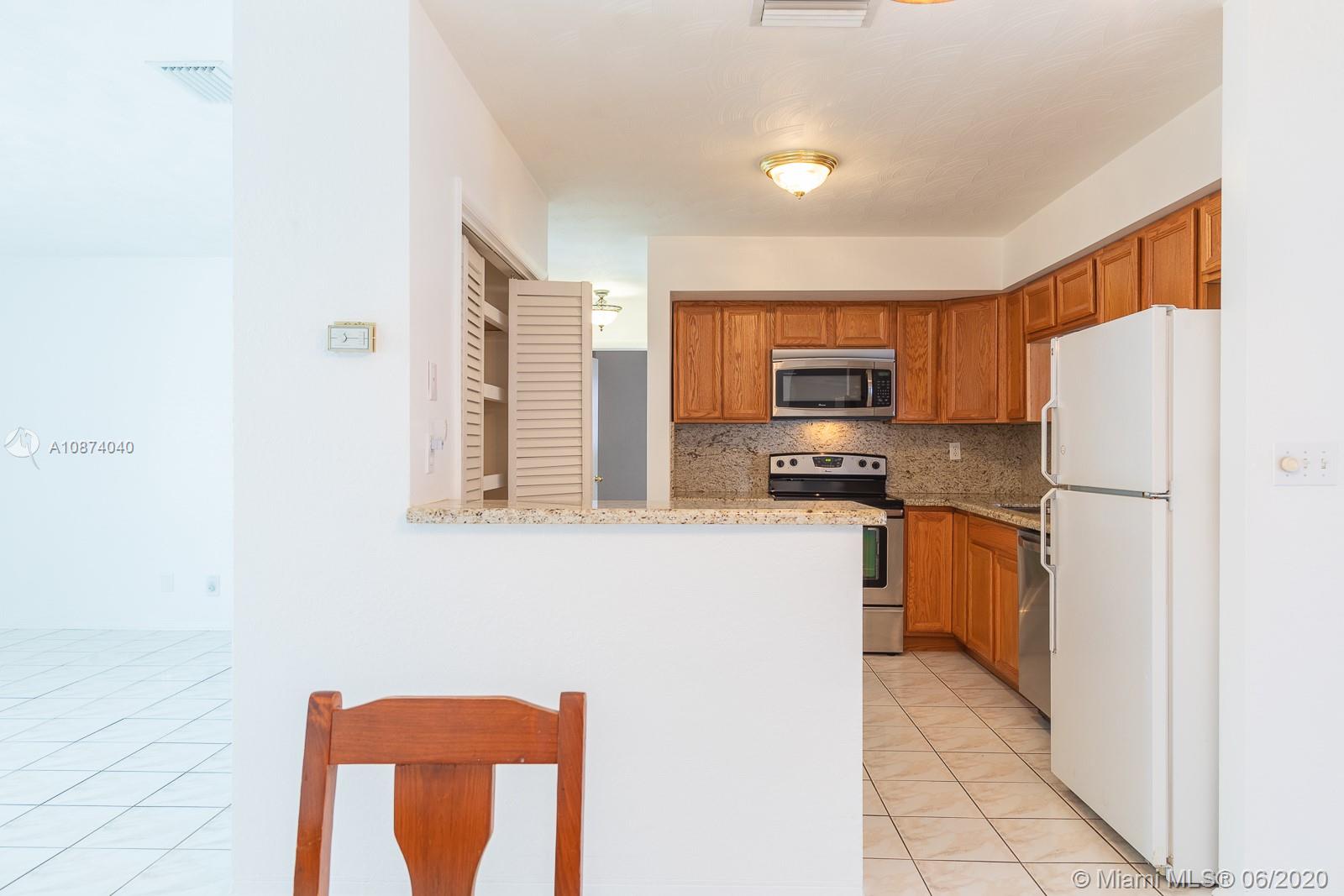 5416 Jefferson Street Hollywood, FL 33021 - Photo 20 of 70 a kitchen with stainless steel appliances a refrigerator stove and microwave
