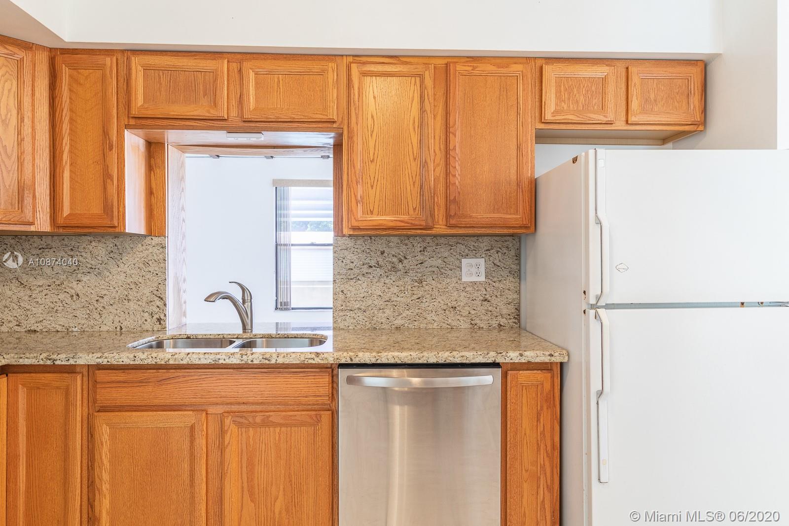 5416 Jefferson Street Hollywood, FL 33021 - Photo 30 of 70 a kitchen with stainless steel appliances granite countertop a refrigerator and a sink