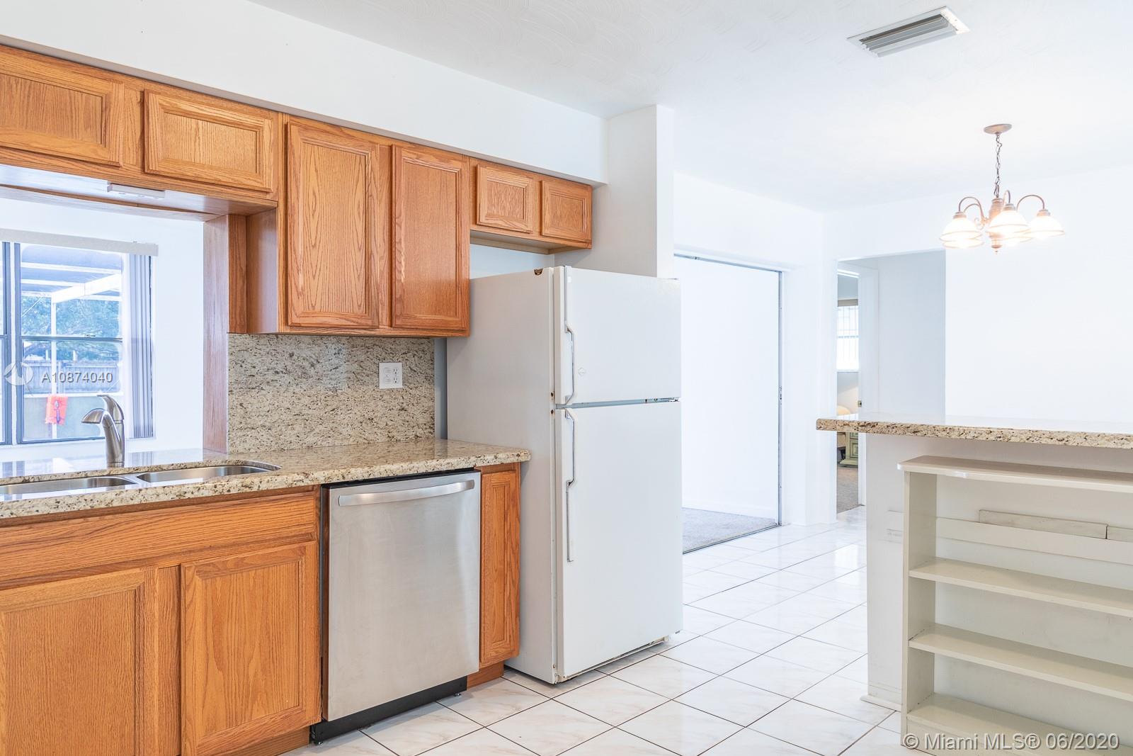 5416 Jefferson Street Hollywood, FL 33021 - Photo 31 of 70 a kitchen with white cabinets and refrigerator