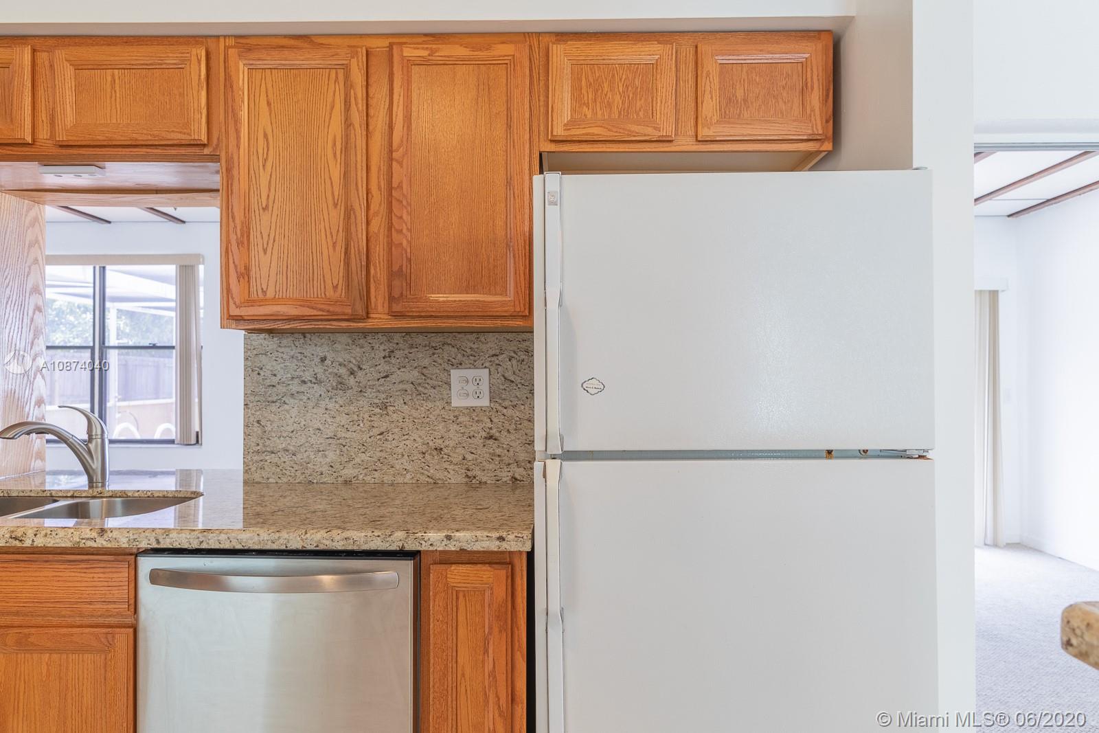 5416 Jefferson Street Hollywood, FL 33021 - Photo 33 of 70 a kitchen with a sink and a refrigerator