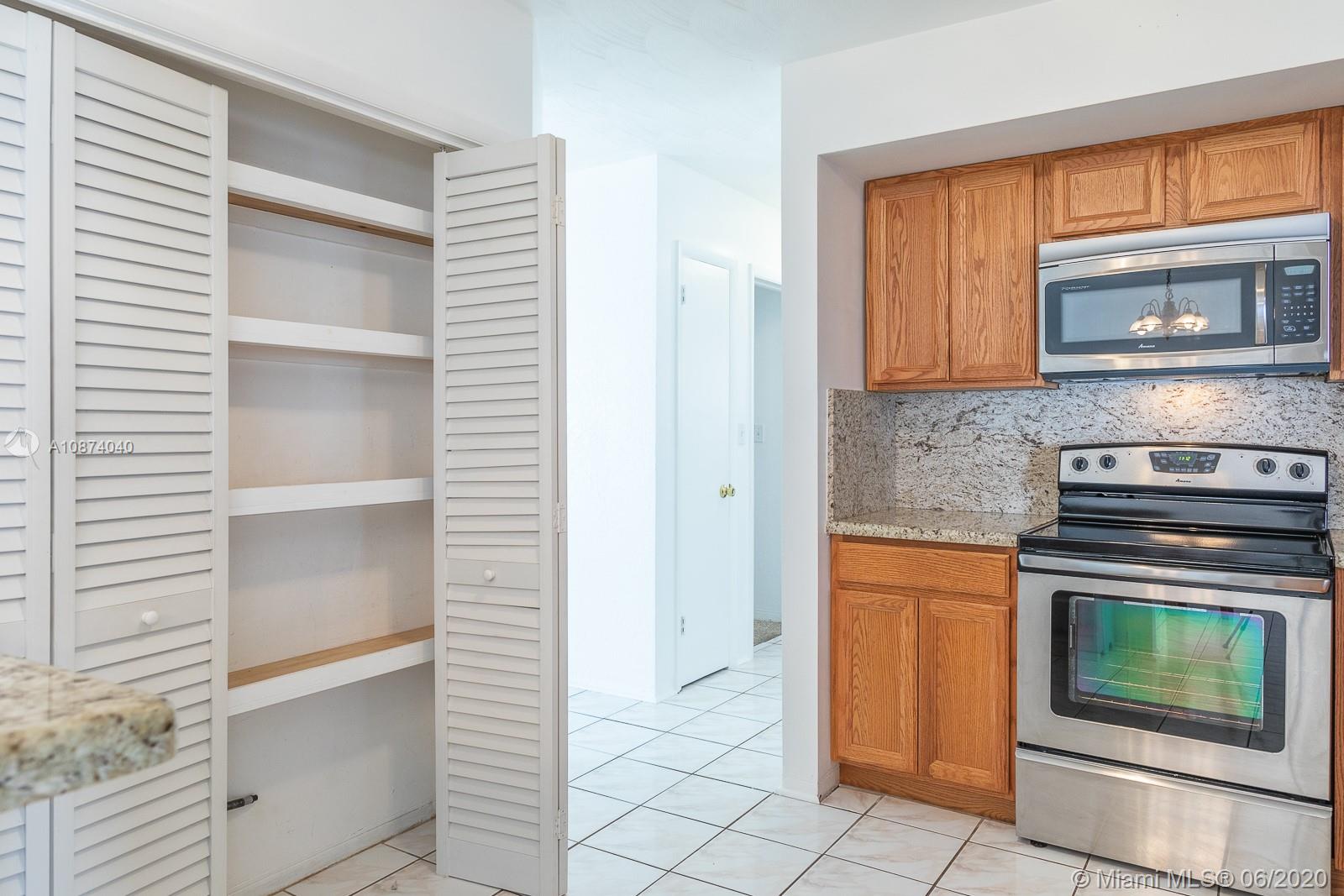 5416 Jefferson Street Hollywood, FL 33021 - Photo 34 of 70 a kitchen with granite countertop a stove top oven