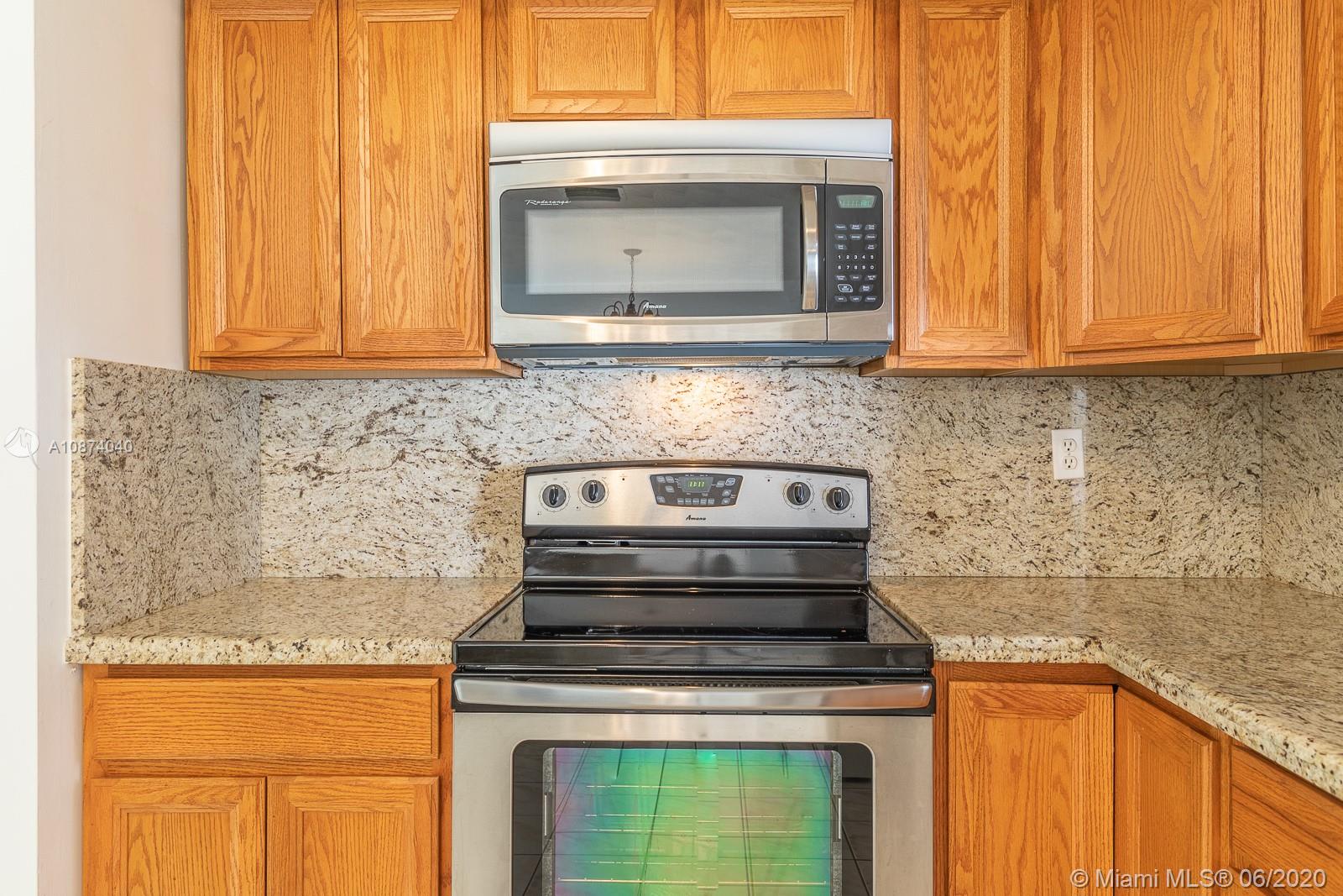 5416 Jefferson Street Hollywood, FL 33021 - Photo 35 of 70 a kitchen with a stove and a microwave