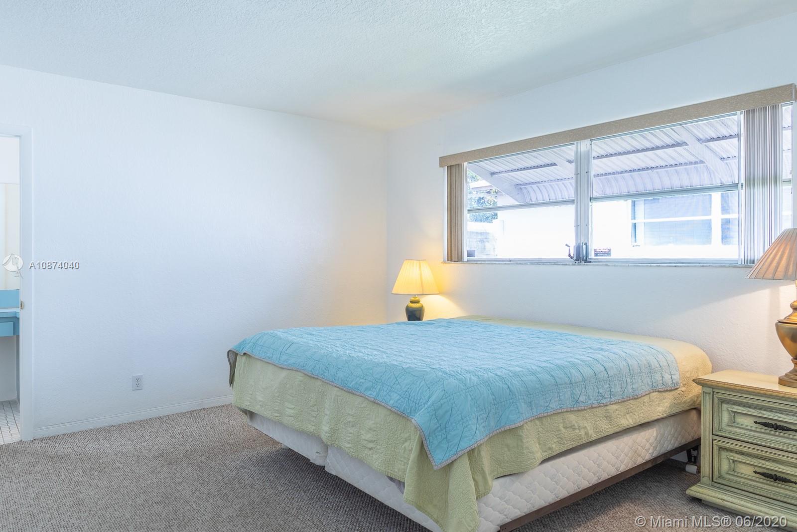 5416 Jefferson Street Hollywood, FL 33021 - Photo 52 of 70 a bedroom with a bed and window