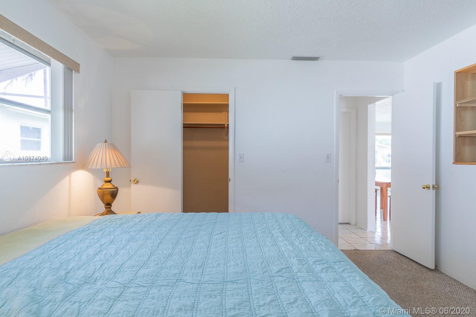 5416 Jefferson Street Hollywood, FL 33021 - Photo 55 of 70 a bedroom with a bed and a window