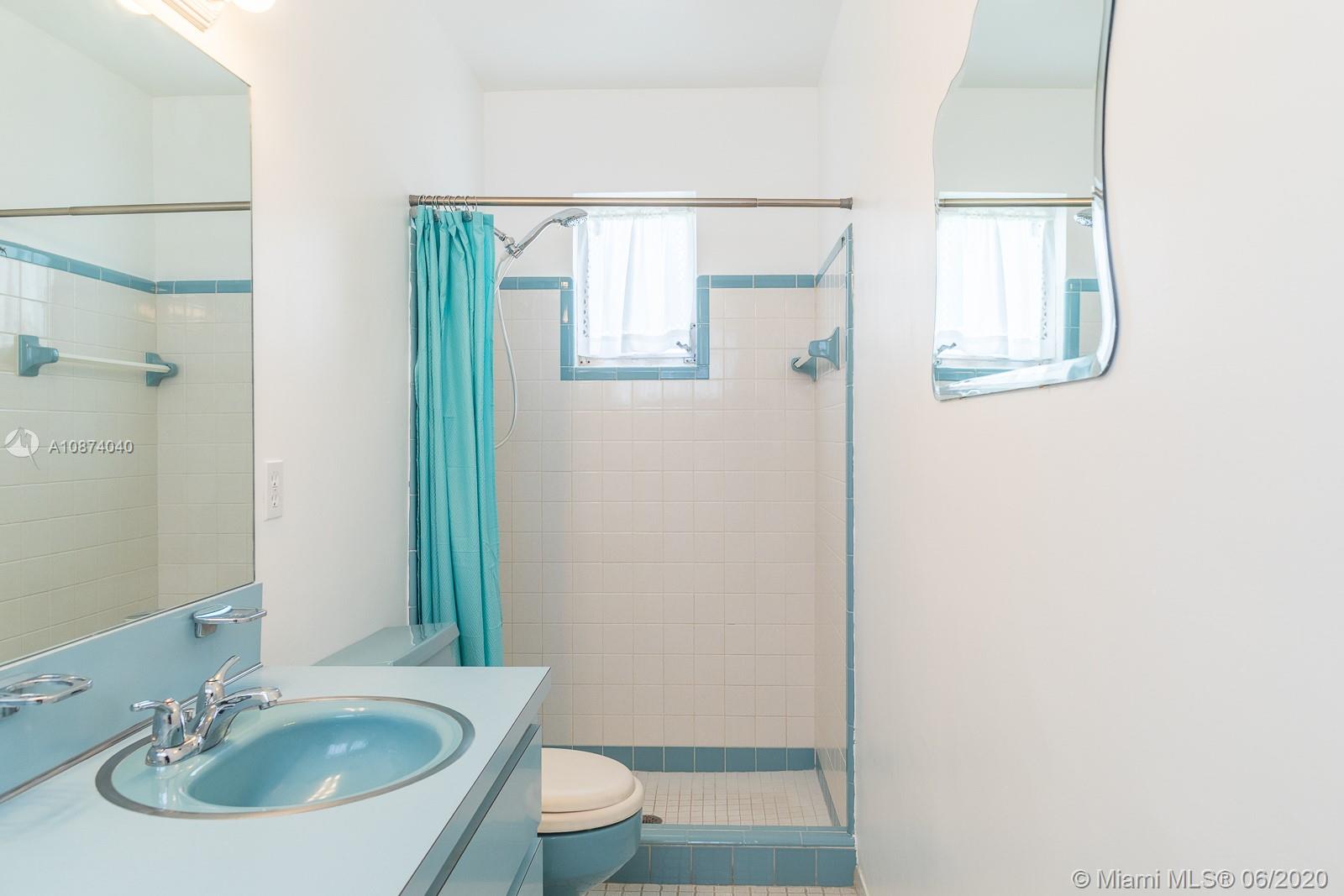 5416 Jefferson Street Hollywood, FL 33021 - Photo 56 of 70 a bathroom with a sink a toilet and a mirror
