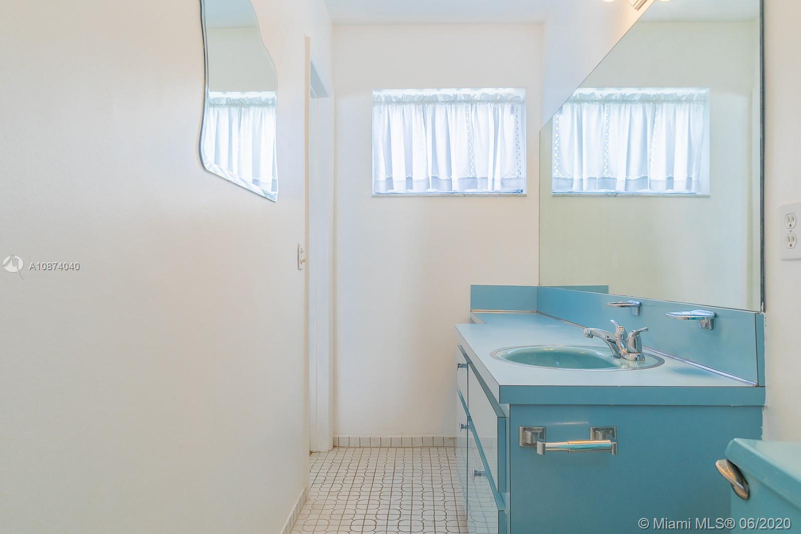 5416 Jefferson Street Hollywood, FL 33021 - Photo 57 of 70 a bathroom with a sink and a mirror