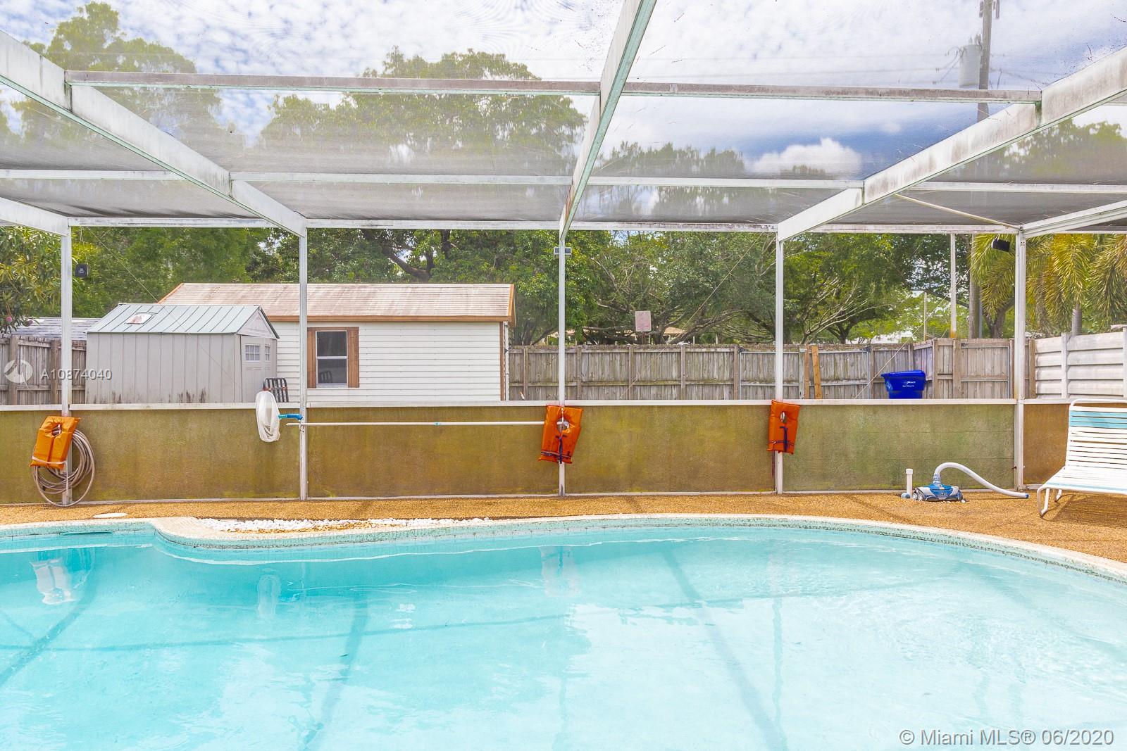 5416 Jefferson Street Hollywood, FL 33021 - Photo 60 of 70 a view of swimming pool with a yard and seating space