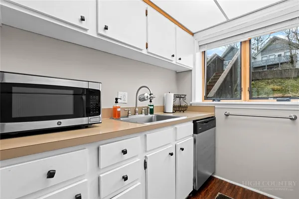 a white stove top oven sitting inside of a kitchen