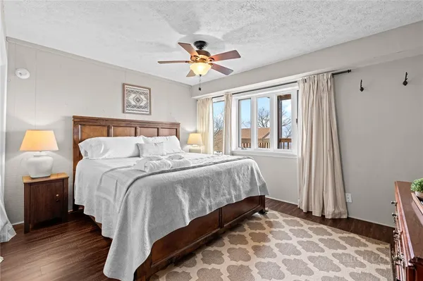 a bedroom with a large bed and a chandelier