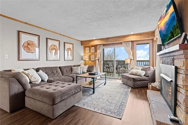 a view of a livingroom and dining room with wooden floor