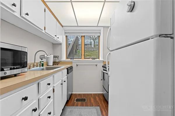 a kitchen with stainless steel appliances a sink and a microwave
