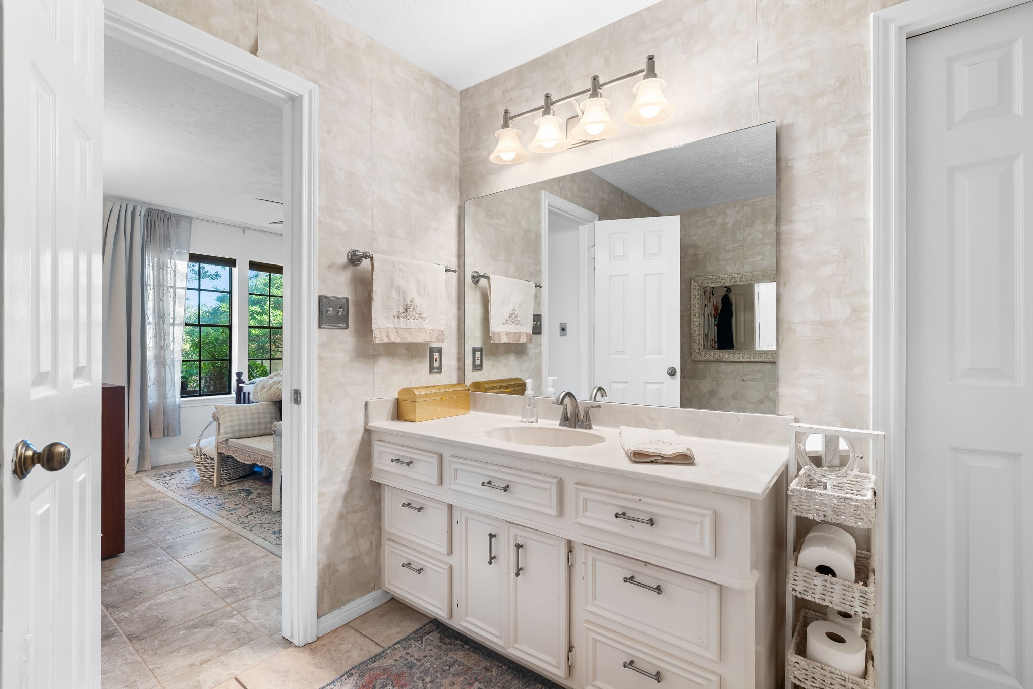 6971 Breezy Point Willis, TX 77318 - Photo 17 of 49 a spacious bathroom with a double vanity sink toilet and a tub