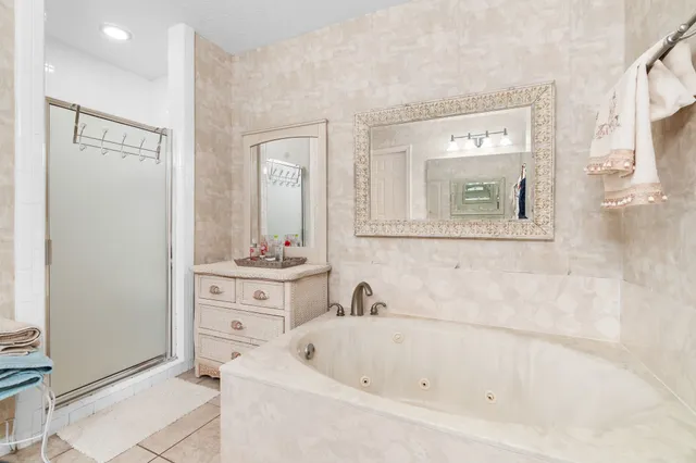a spacious bathroom with a double vanity sink toilet and a tub