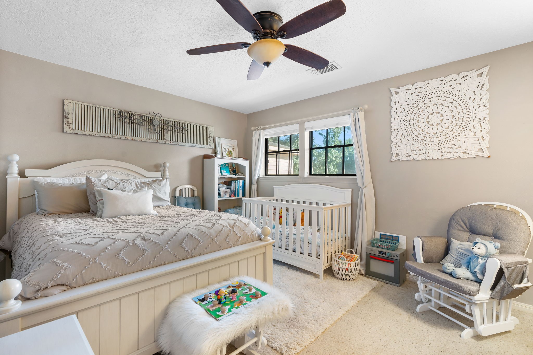 6971 Breezy Point Willis, TX 77318 - Photo 21 of 49 a bedroom with a bed and a chandelier