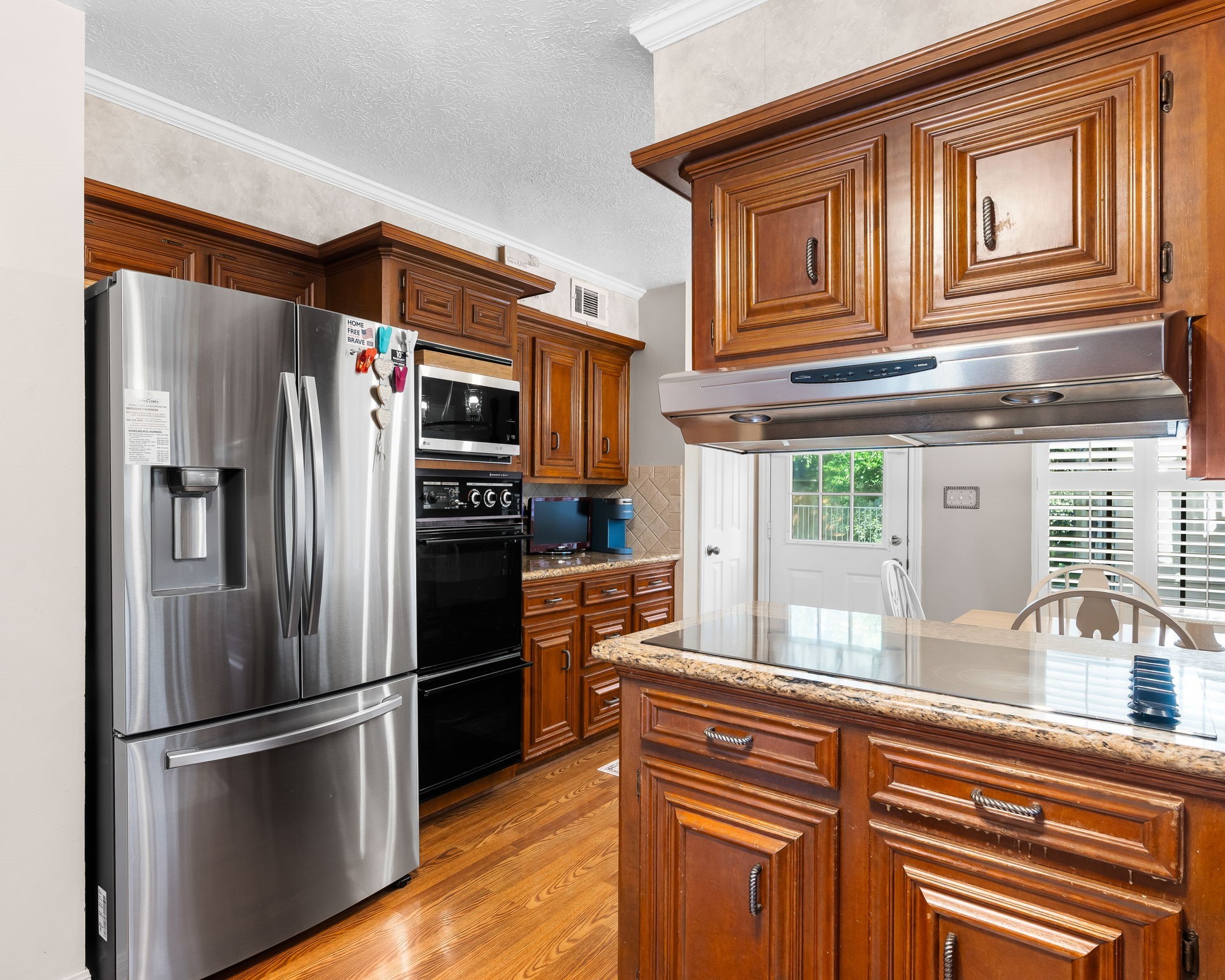6971 Breezy Point Willis, TX 77318 - Photo 8 of 49 a kitchen with stainless steel appliances granite countertop a refrigerator and a sink