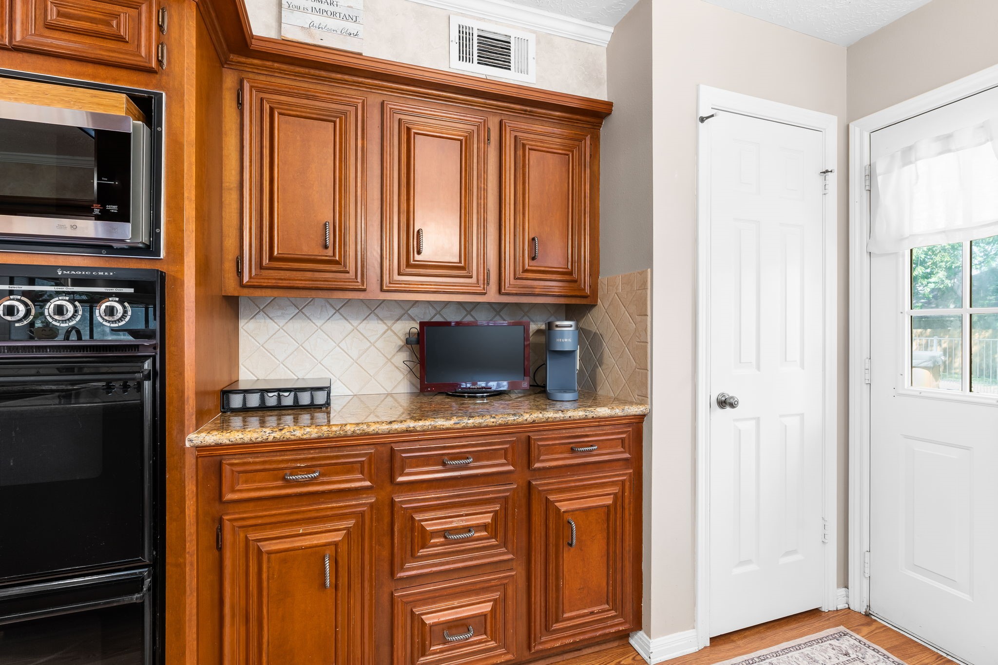 6971 Breezy Point Willis, TX 77318 - Photo 9 of 49 a kitchen with stainless steel appliances granite countertop a refrigerator and a stove top oven